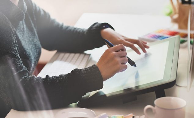 Stock illustration showing a person using a drawing tablet. Image used in the “What Drawing Tablet Should You Get” blog post.